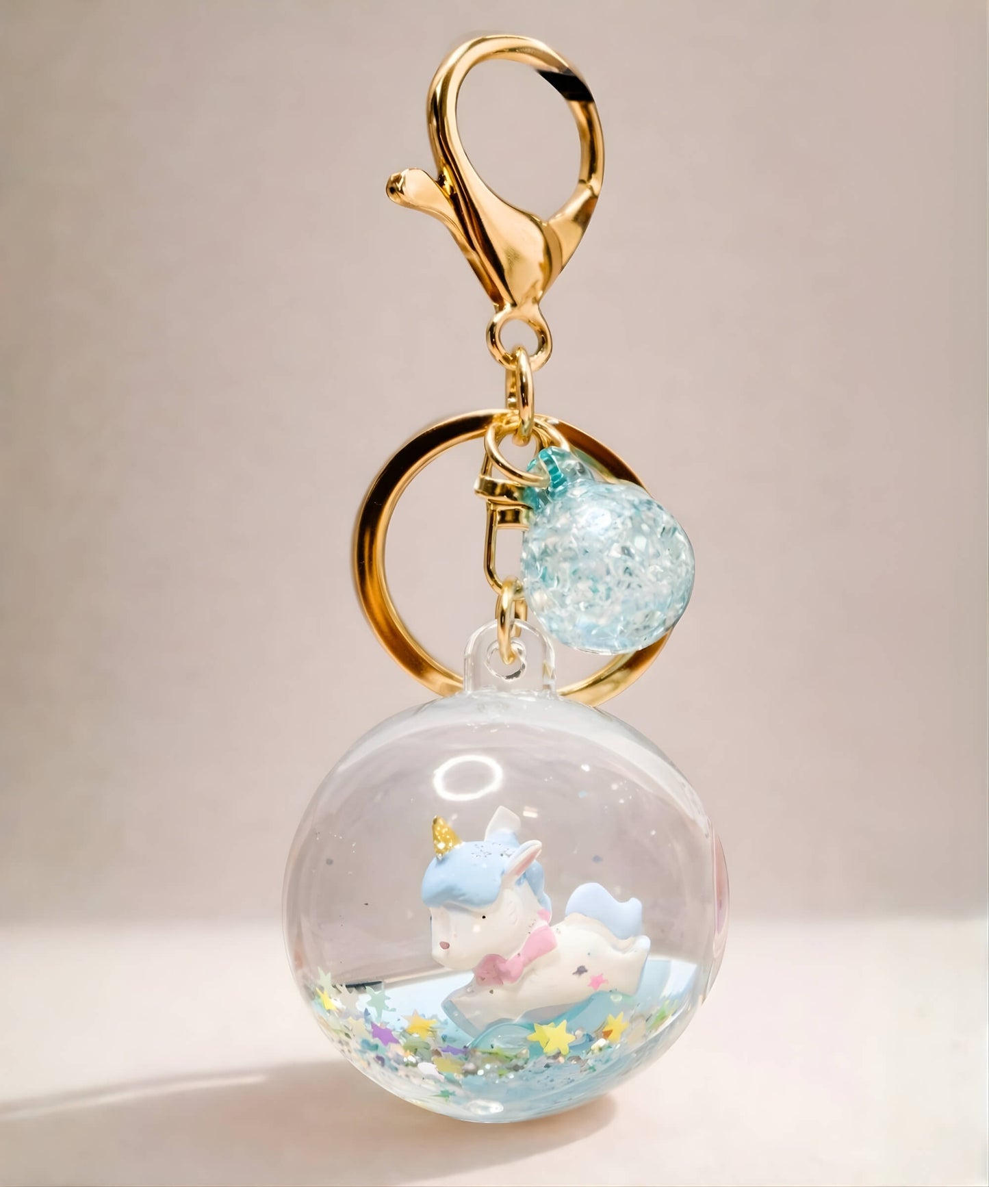 Blue unicorn liquid glitter keychain with floating stars inside acrylic crystal ball