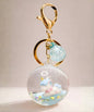 Blue unicorn liquid glitter keychain with floating stars inside acrylic crystal ball