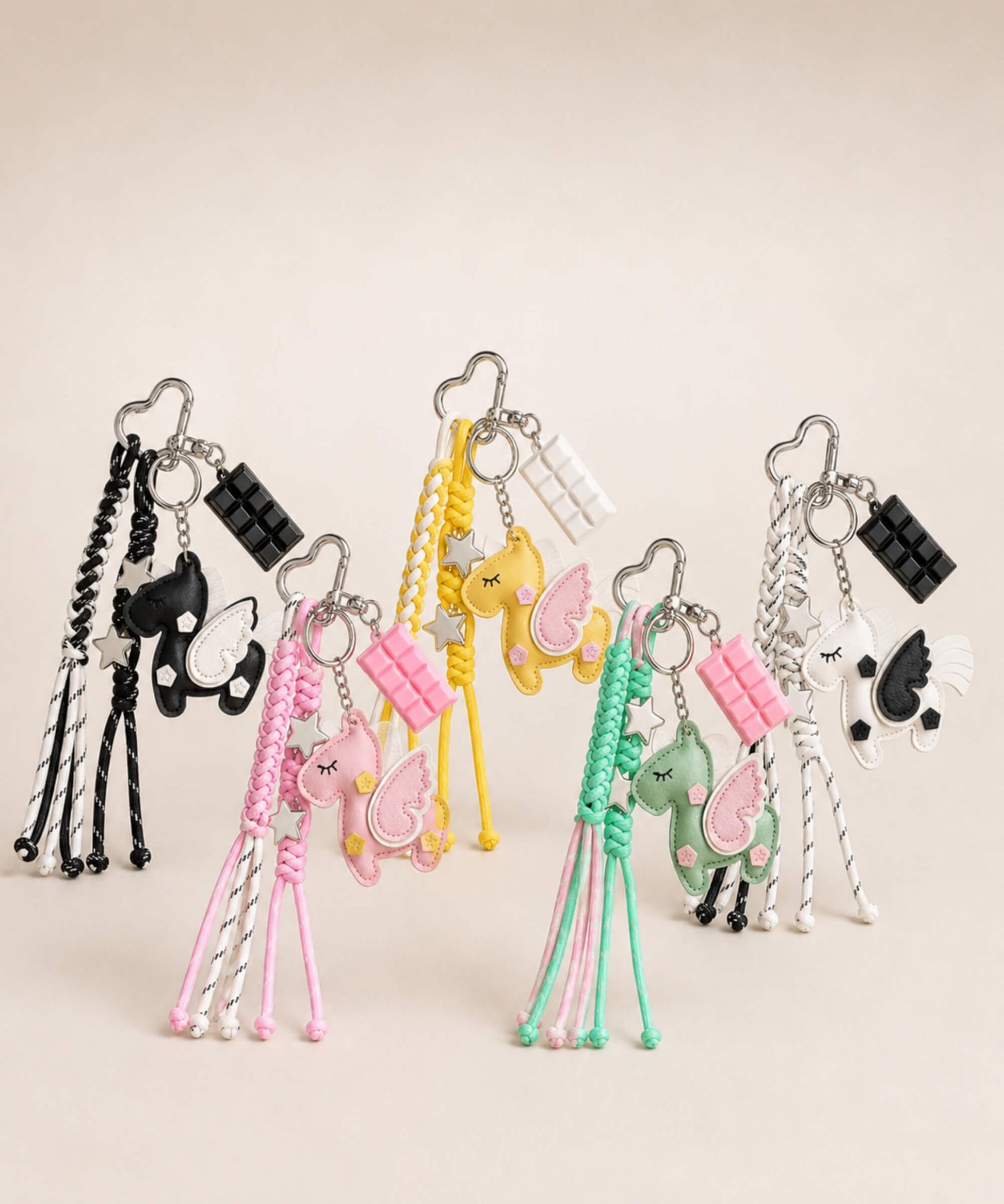 CHARMAZING unicorn PU leather bag charm keychains in black, pink, yellow, green and white.