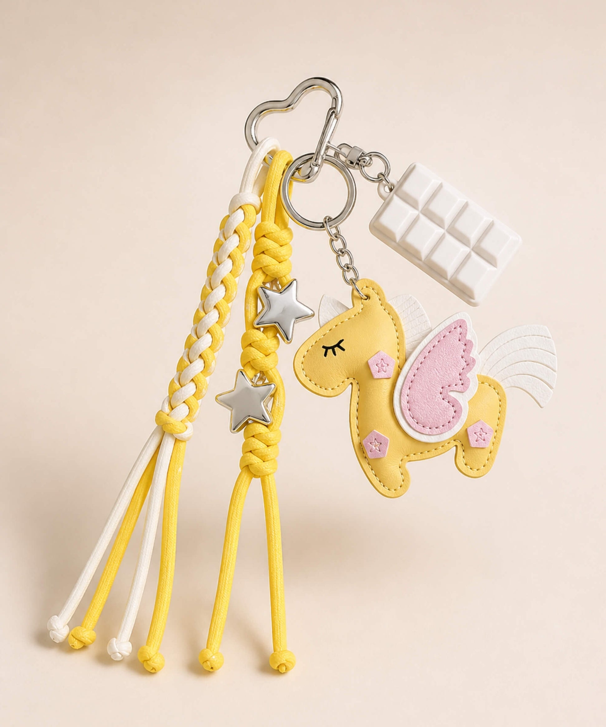 Yellow unicorn PU leather bag charm keychain with pink wing, star charms and white chocolate charm.