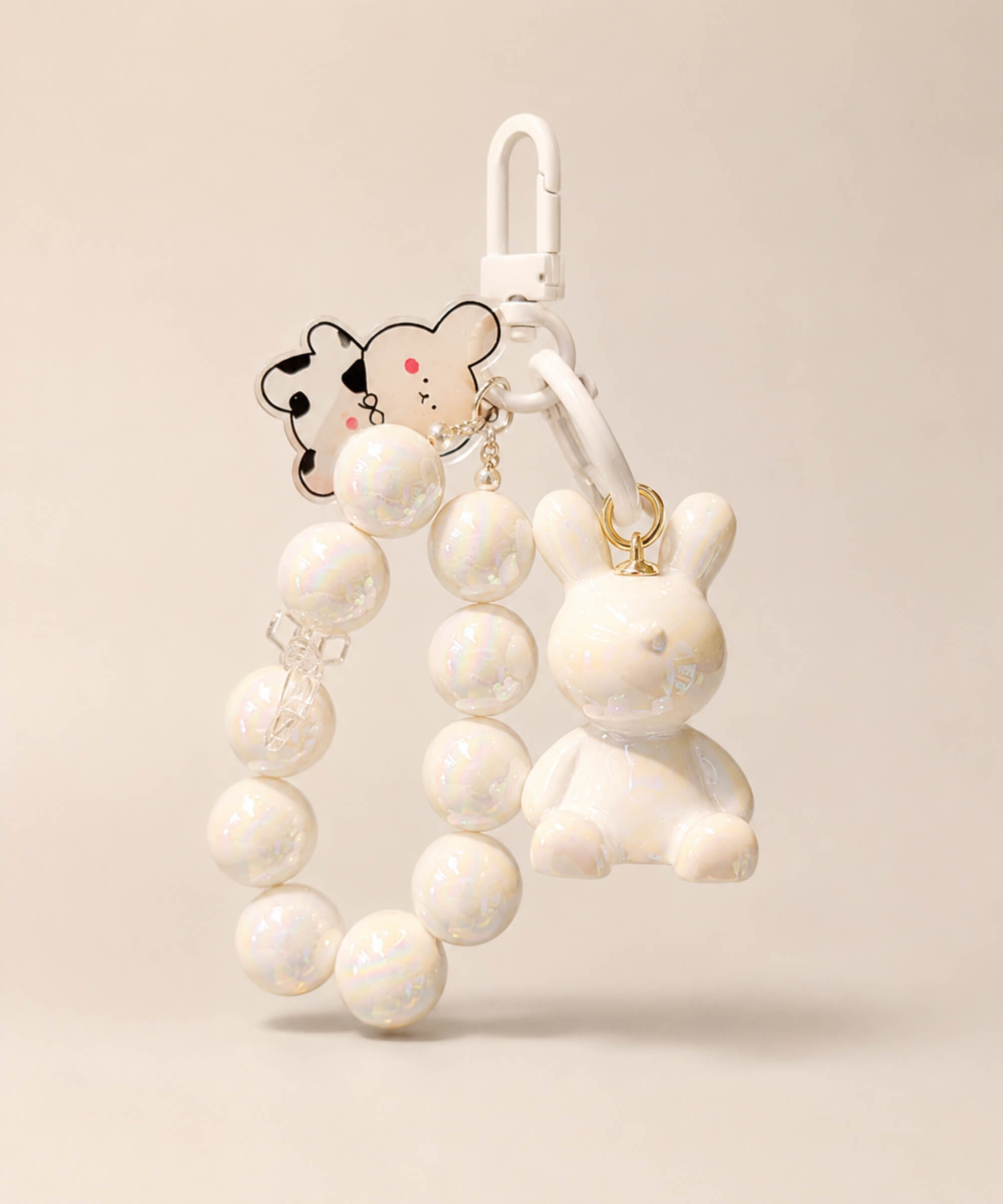 White bunny beaded keychain with rabbit charm and bow detail on a neutral background