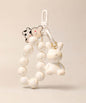White bunny beaded keychain with rabbit charm and bow detail on a neutral background