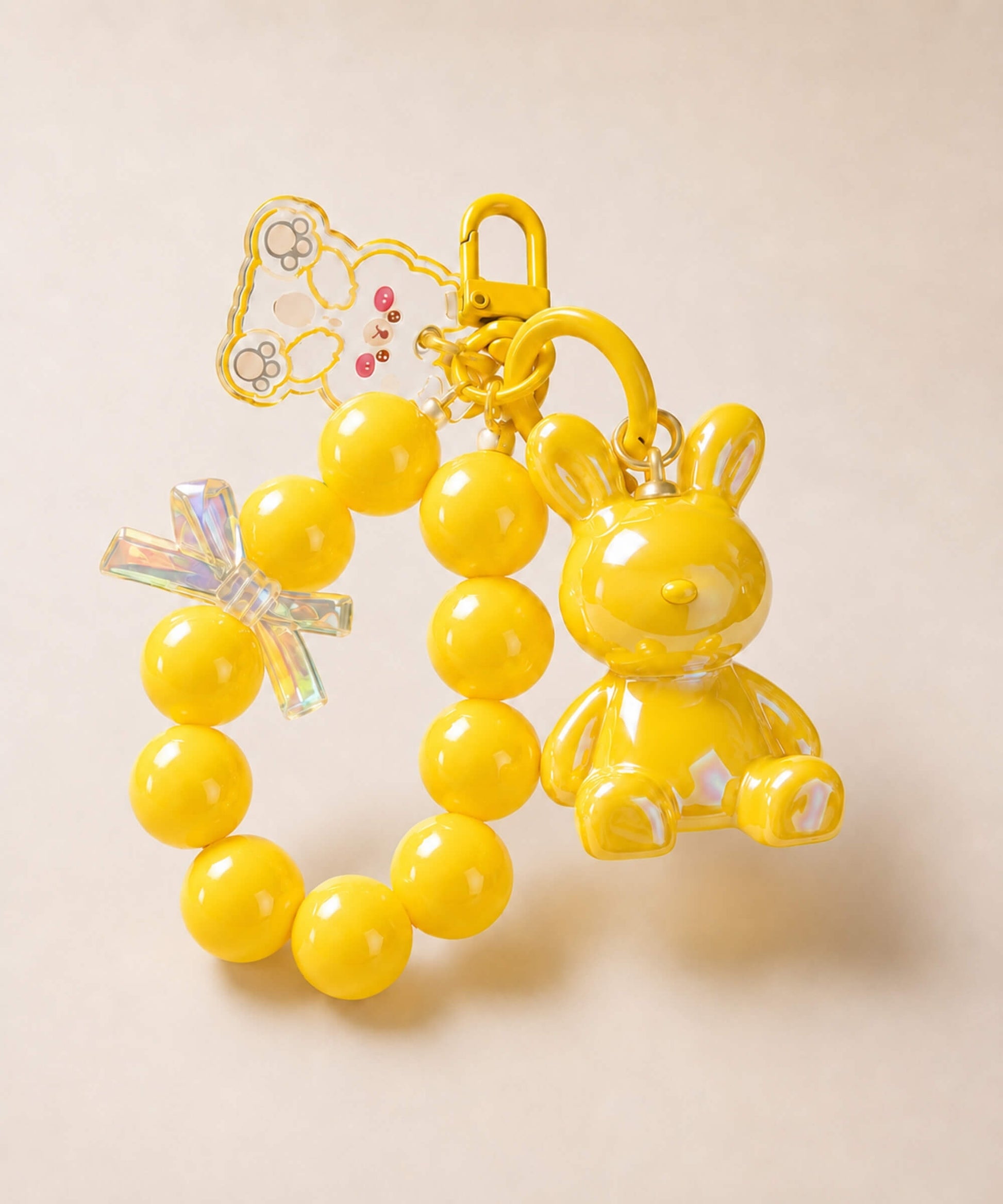 Yellow bunny beaded keychain with rabbit charm and bow detail on a neutral background