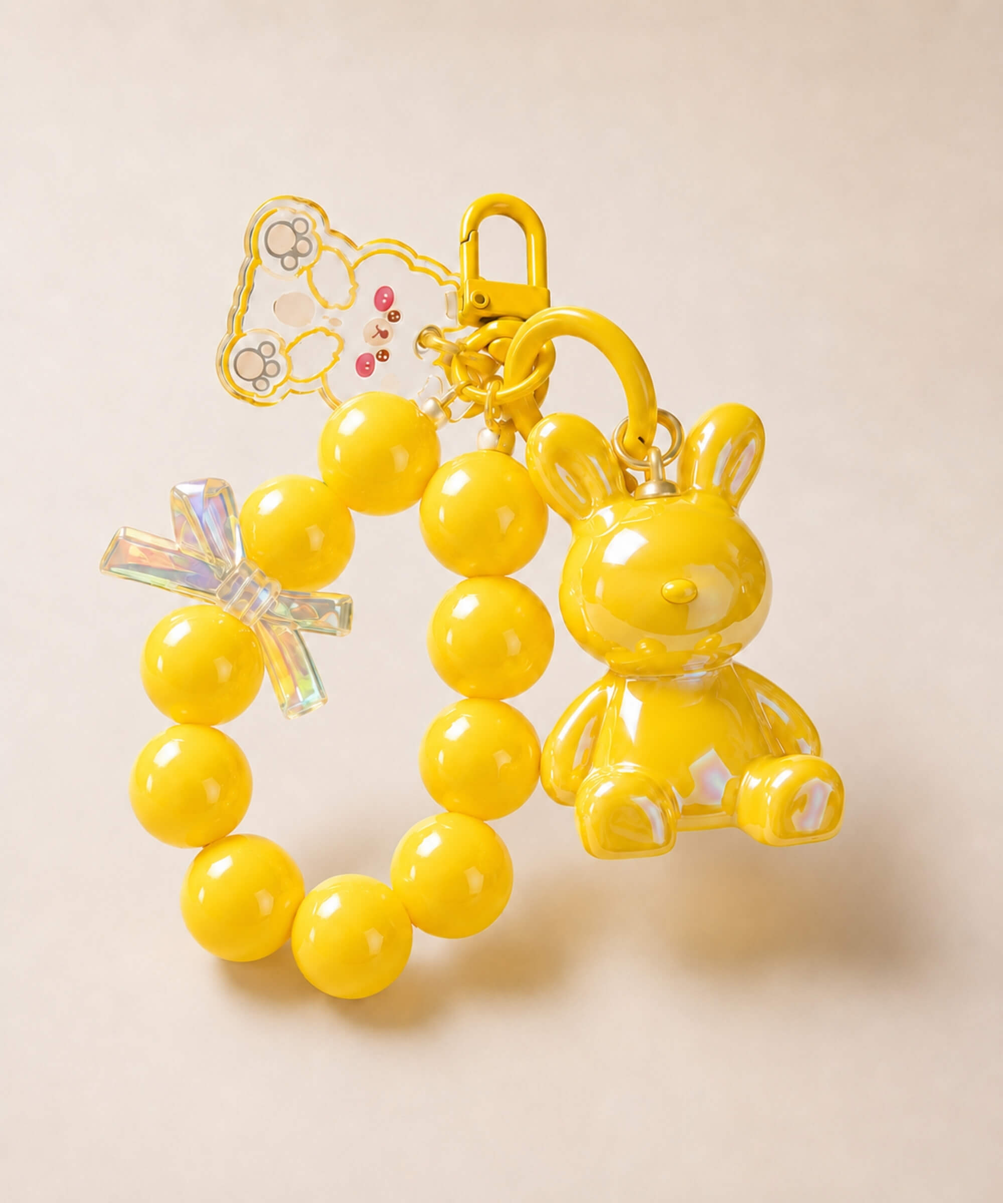 Yellow bunny beaded keychain with rabbit charm and bow detail on a neutral background