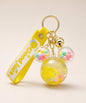 Yellow Mickey head liquid keychain with yellow glitter, pastel beads, yellow strap and gold hardware