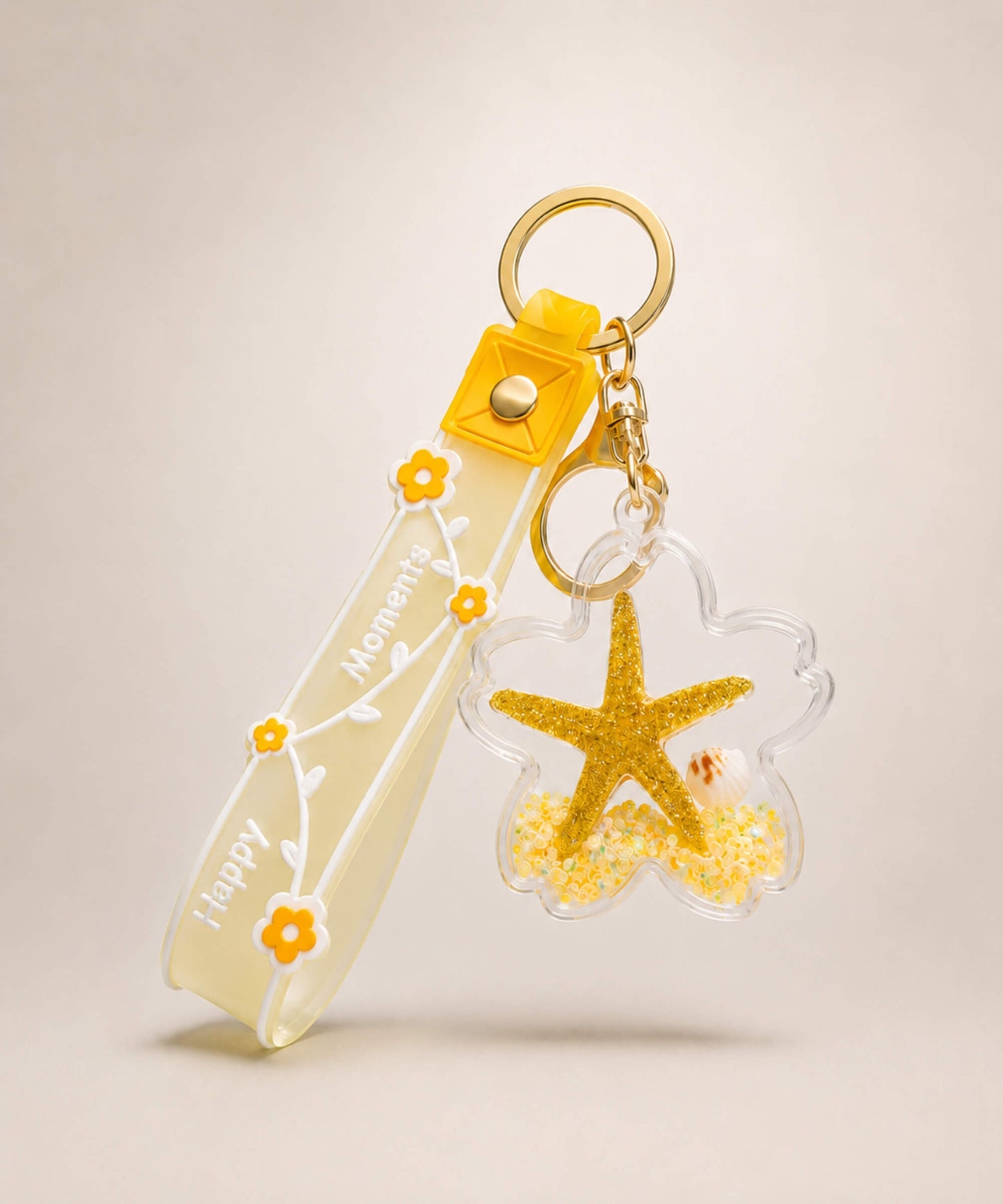 Yellow starfish liquid keychain with yellow glitter, shell detail, floral strap and gold hardware