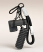 Black yoga rope keychain with black foam roller charm and black yoga mat charm on a neutral background