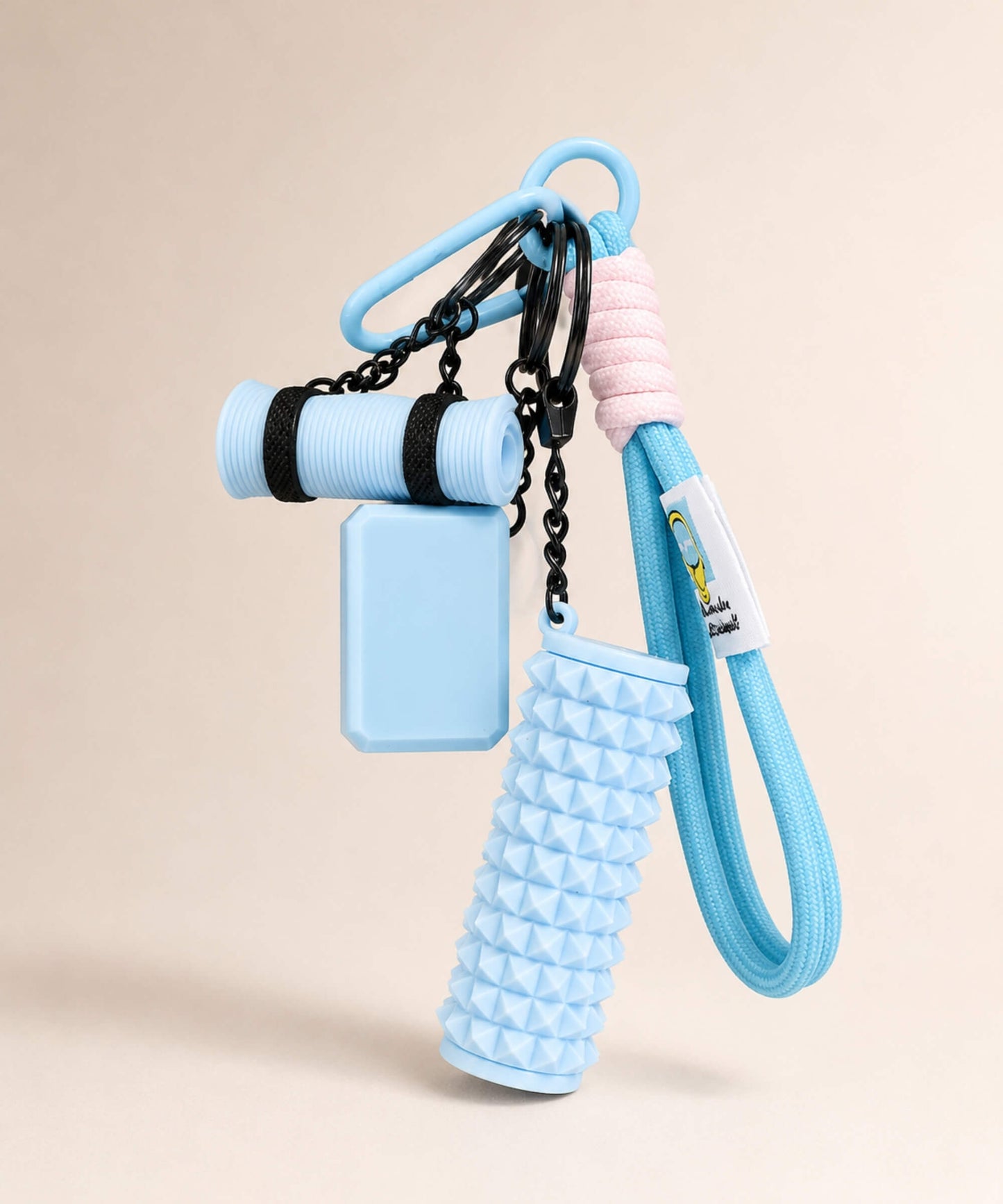 Blue yoga rope keychain with mini foam roller charm on a neutral background