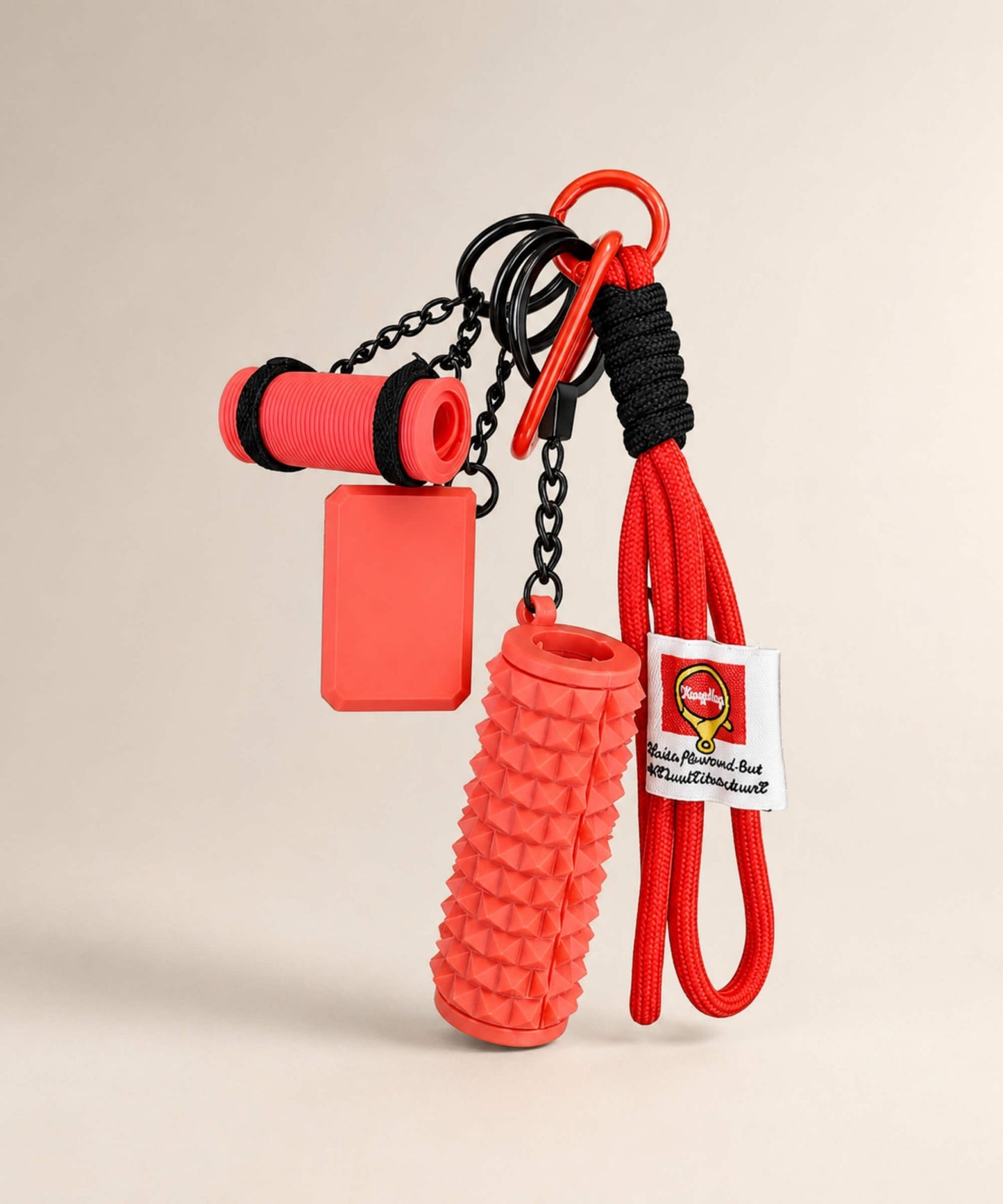 Red yoga rope keychain with mini foam roller charm on a neutral background
