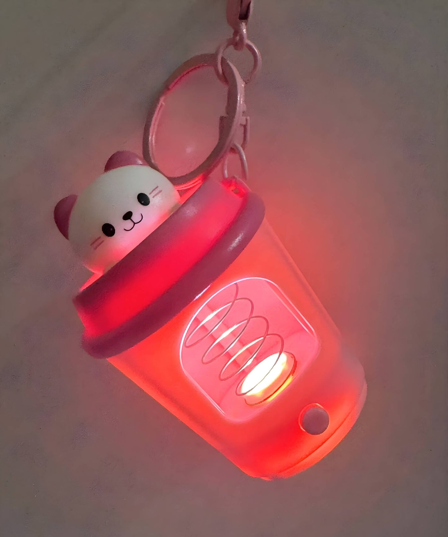 LED coffee cup keychain glowing angle view light-up spring animal charm