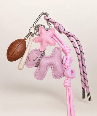Pink dog sports PU leather bag charm keychain with baseball bat, football and rope details