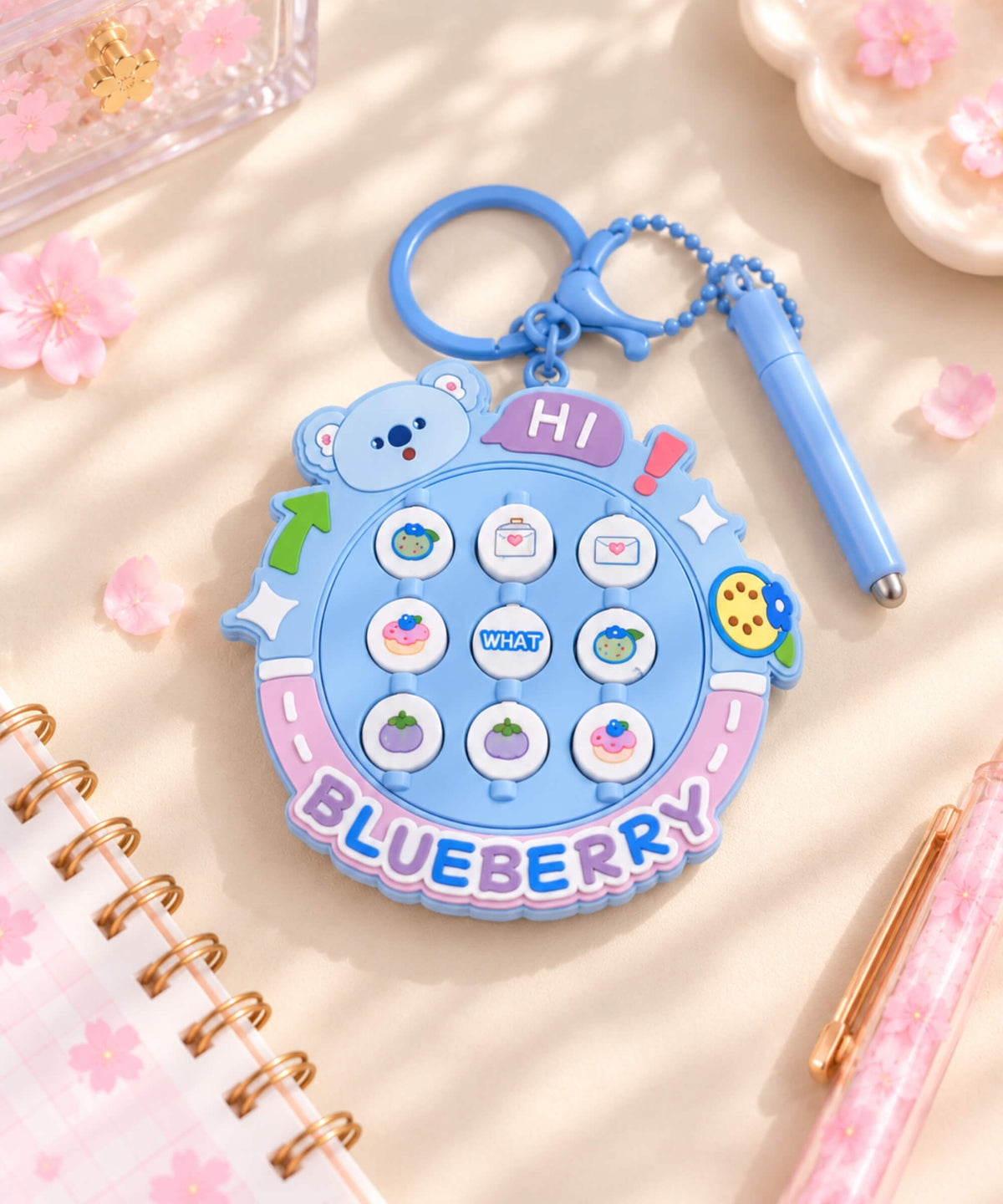 Blueberry Flip Matching Game Keychain styled on a pink desk