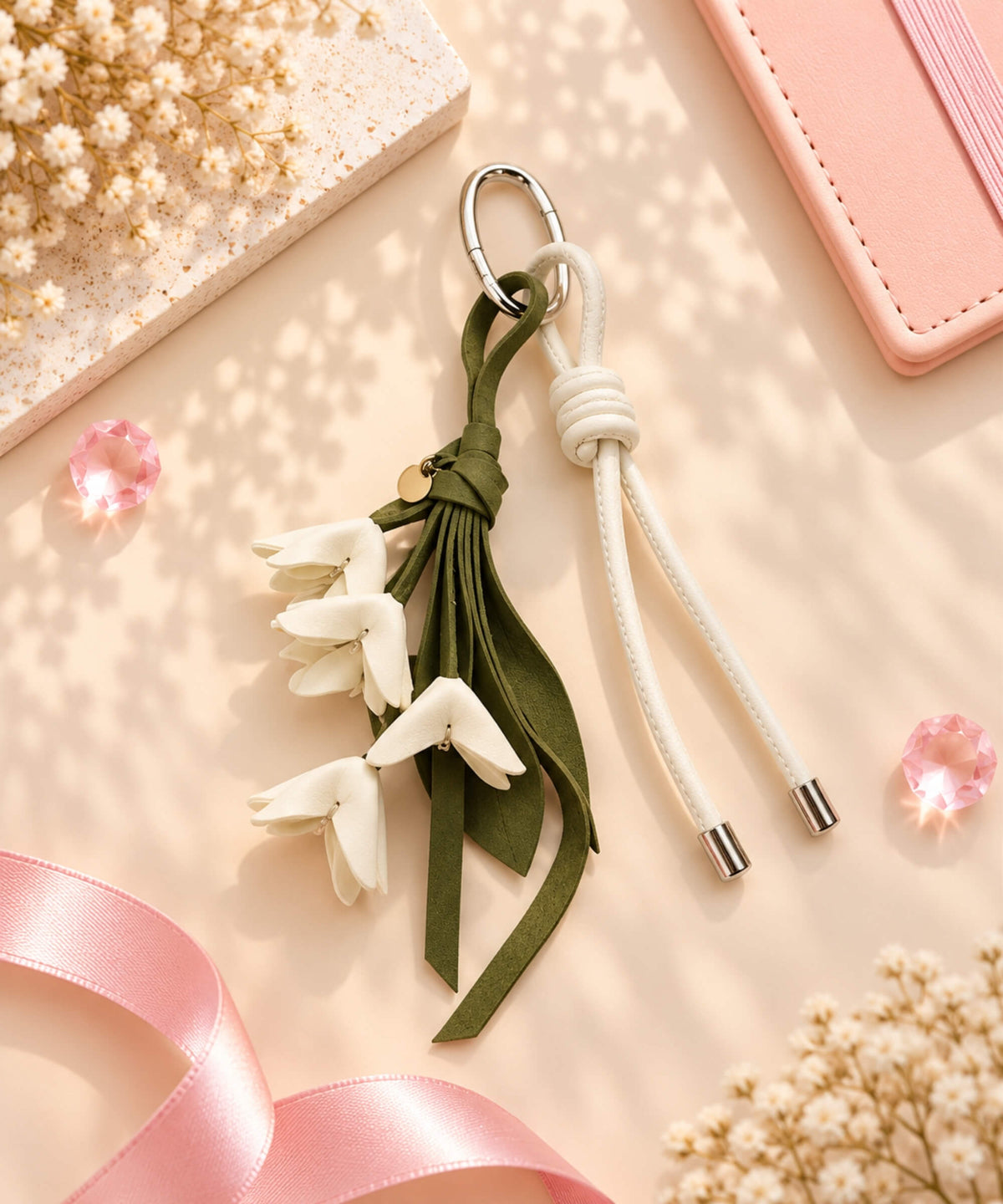 White floral PU leather bag charm keychain with cascading flowers and green leaves