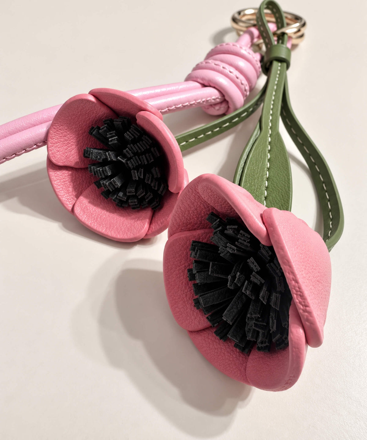 Close-up of pink Poppy PU leather-look flowers with layered black centre detail
