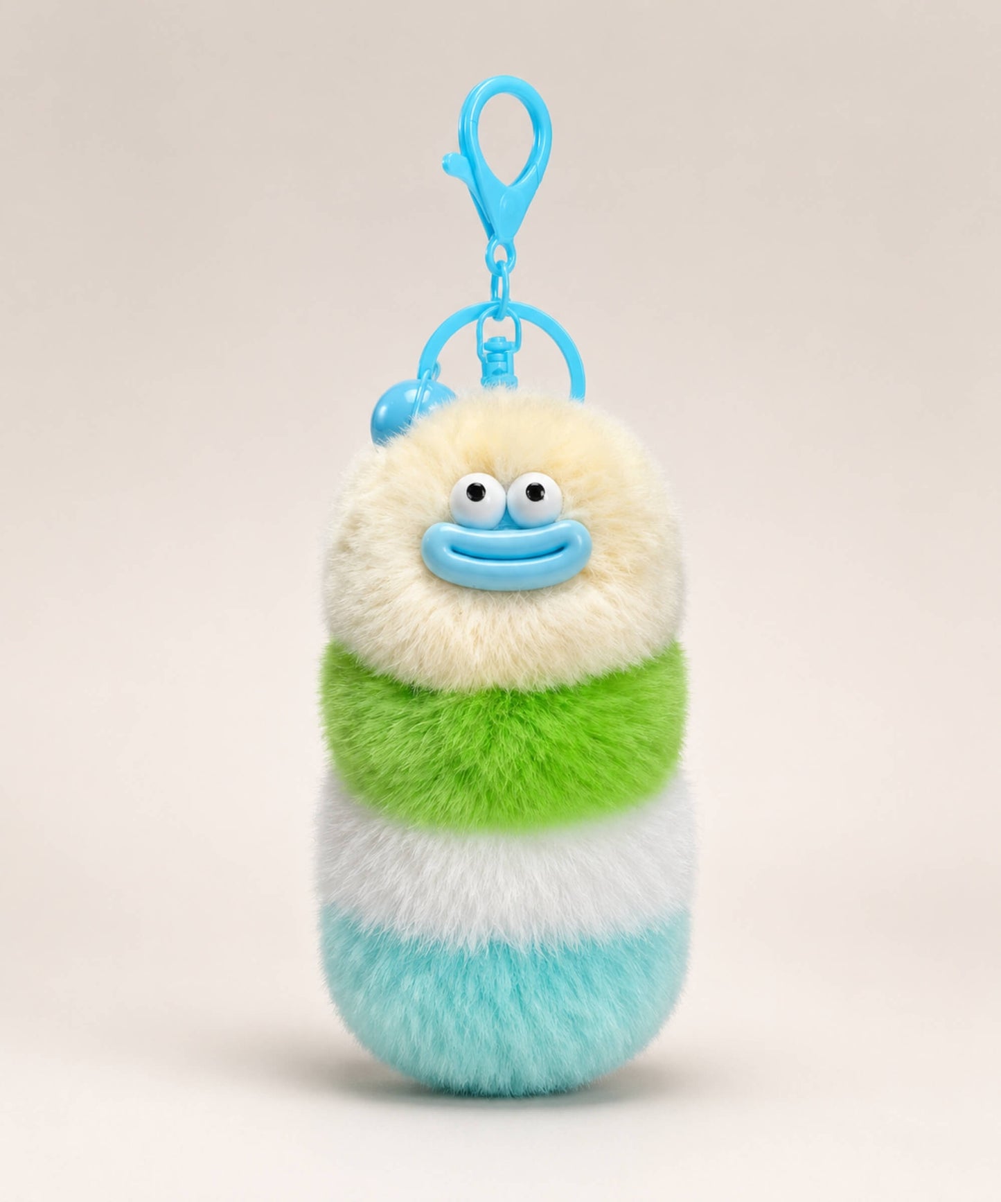 Cream fluffy caterpillar plush keychain with cream, green, white and aqua layers