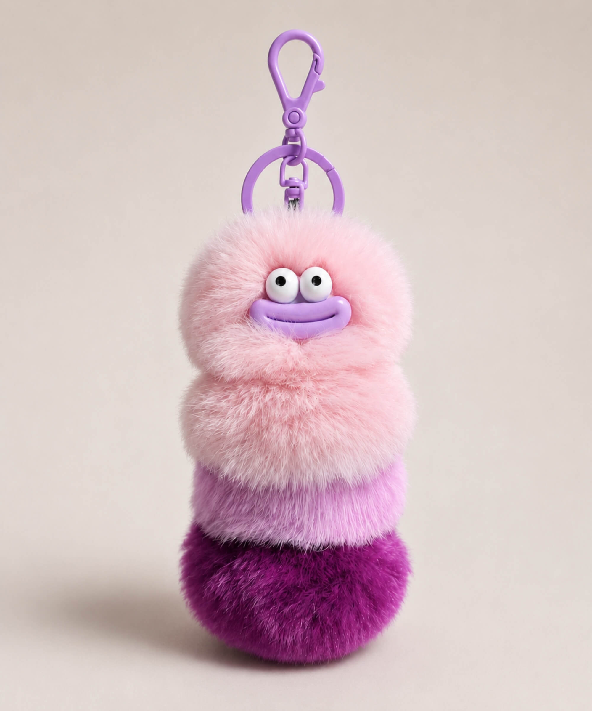 Purple fluffy caterpillar plush keychain with pink and purple layers, cute face and purple clip