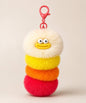 Red fluffy caterpillar plush keychain with cream, yellow, orange and red layers