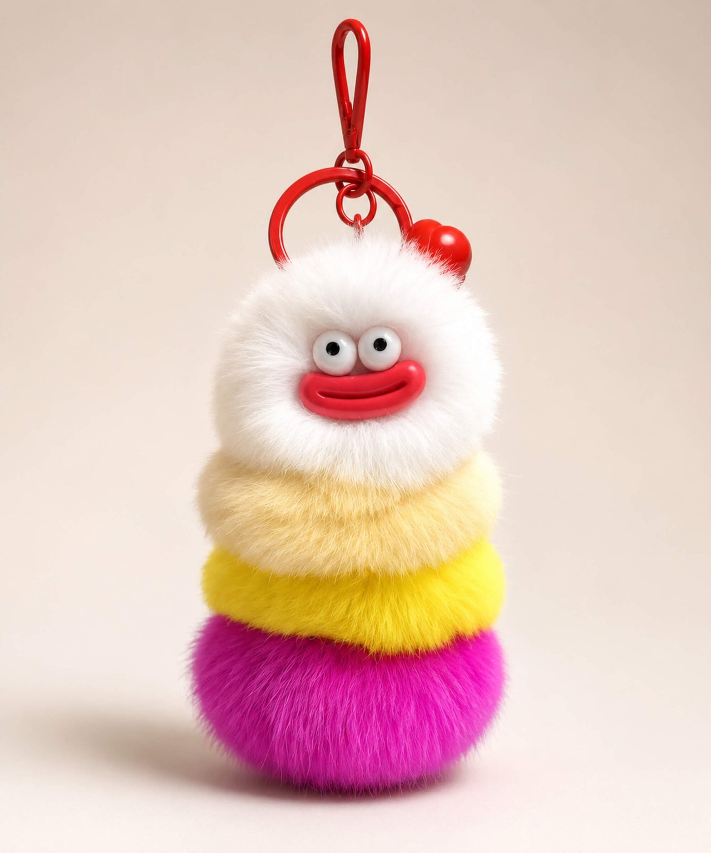 Rose pink fluffy caterpillar plush keychain with cream, yellow, orange and rose pink layers