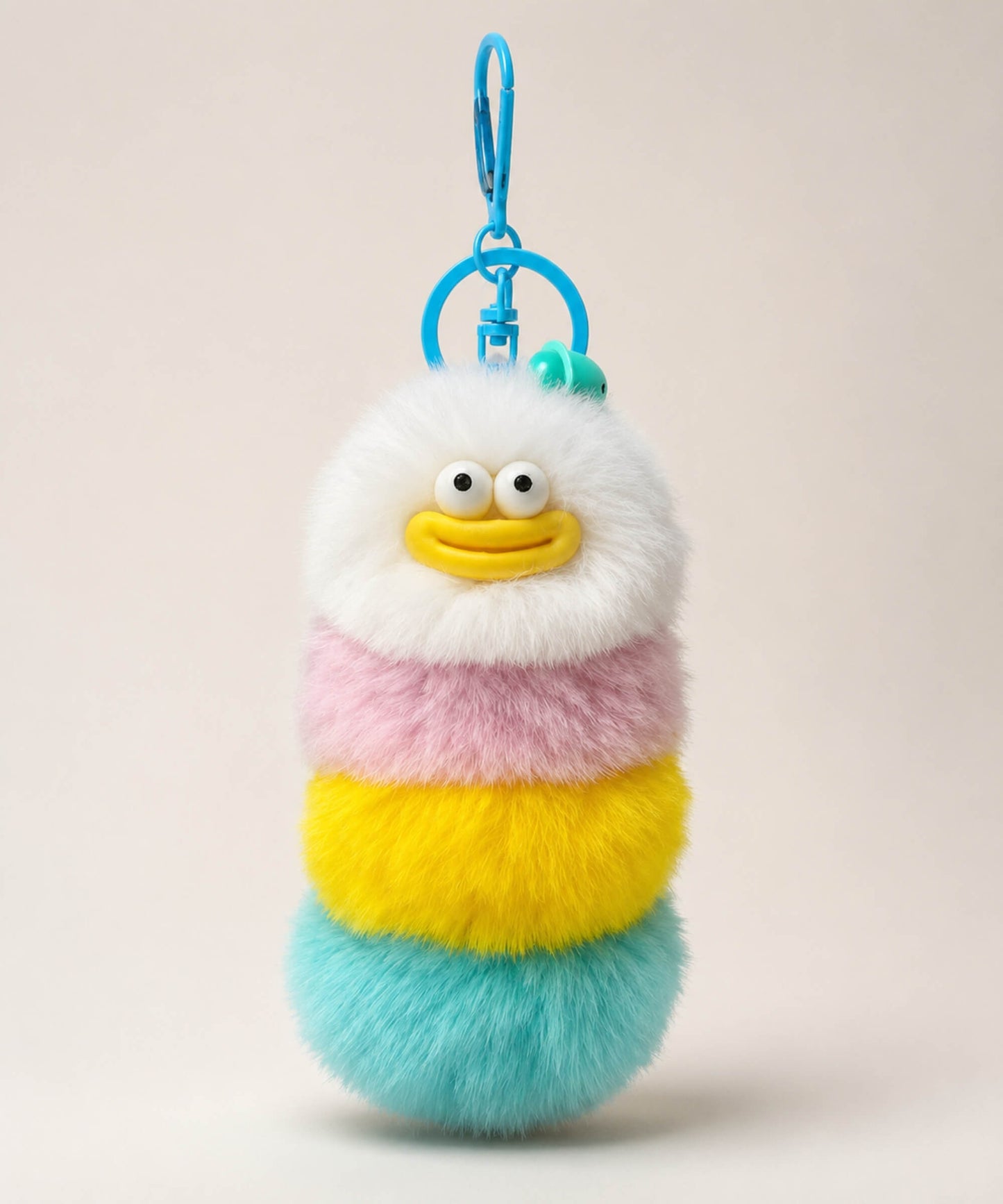 Yellow fluffy caterpillar plush keychain with cream, pink, yellow and aqua layers