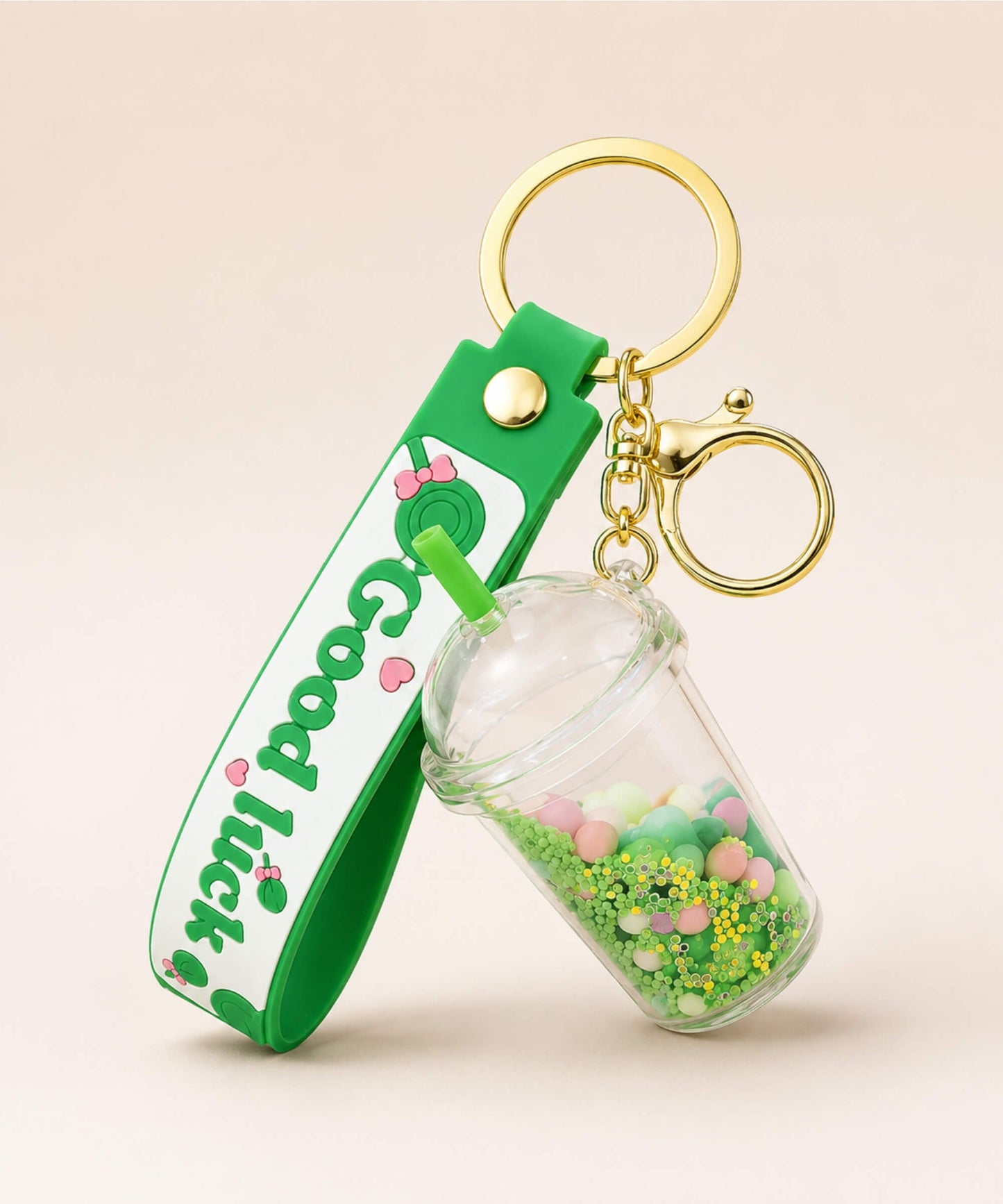 Green bubble tea cup liquid keychain with floating beads and gold hardware