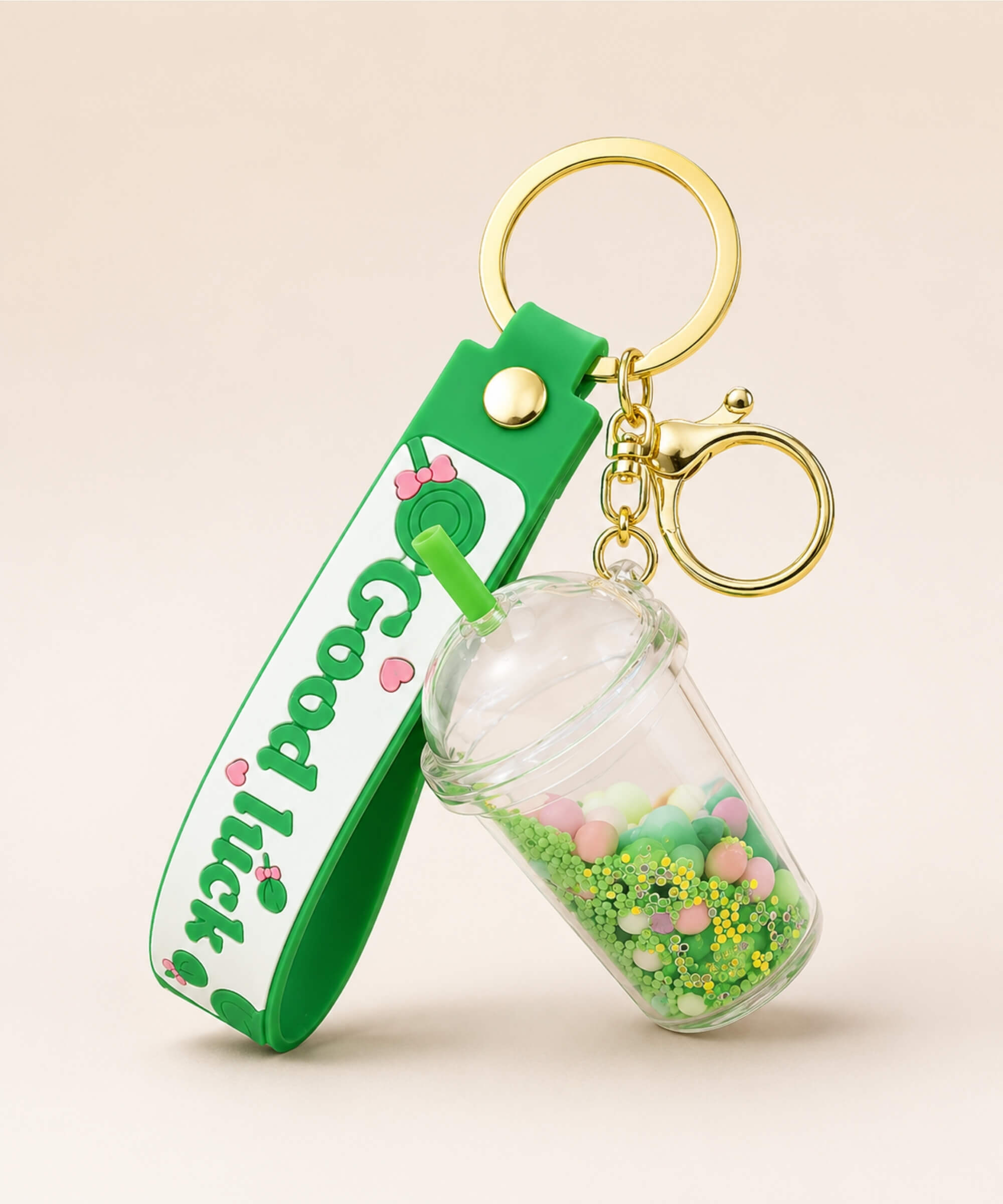 Green bubble tea cup liquid keychain with floating beads and gold hardware