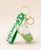 Green bubble tea cup liquid keychain with floating beads and gold hardware
