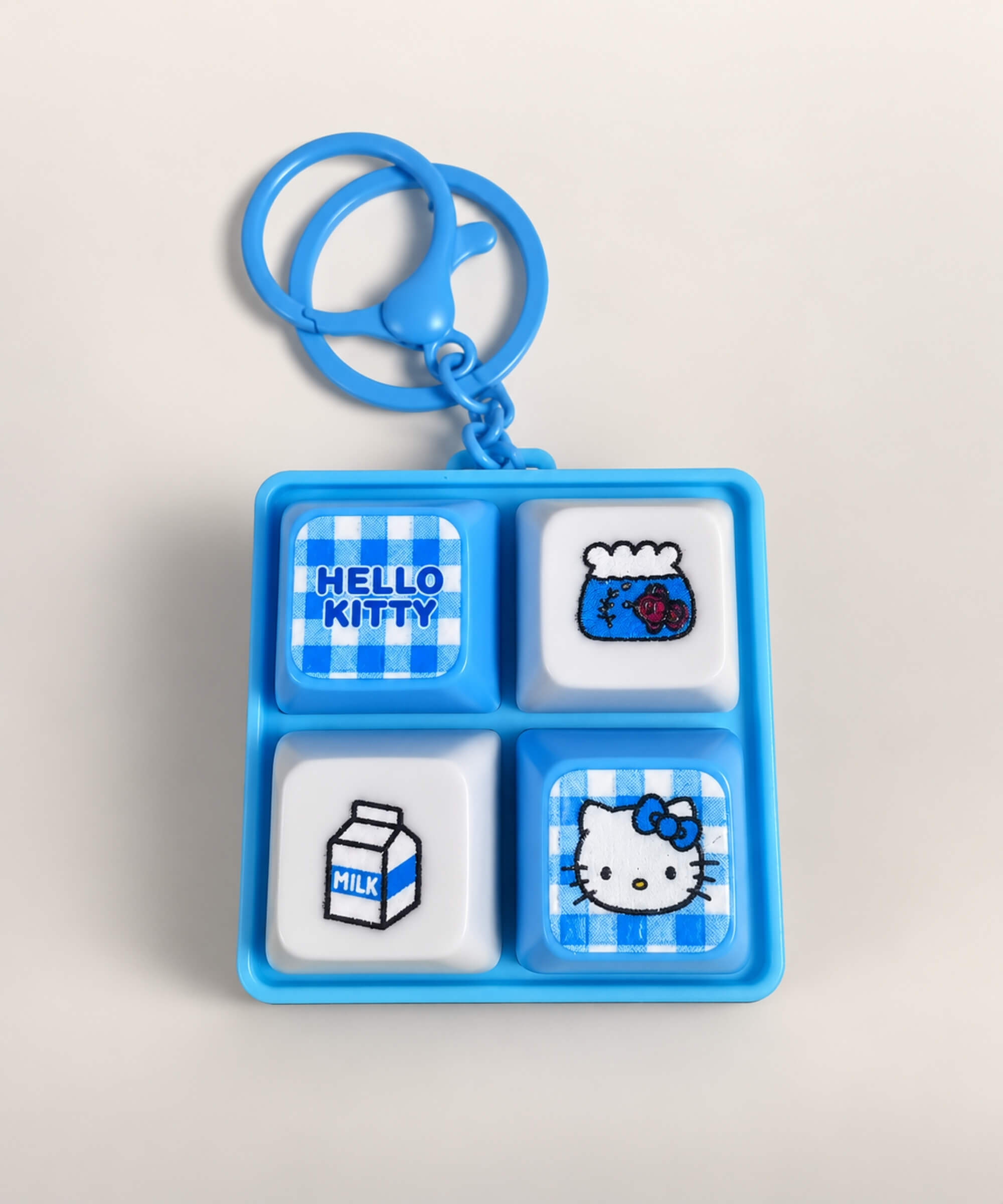 Blue Hello Kitty light up sound button keychain with milk carton and character button designs