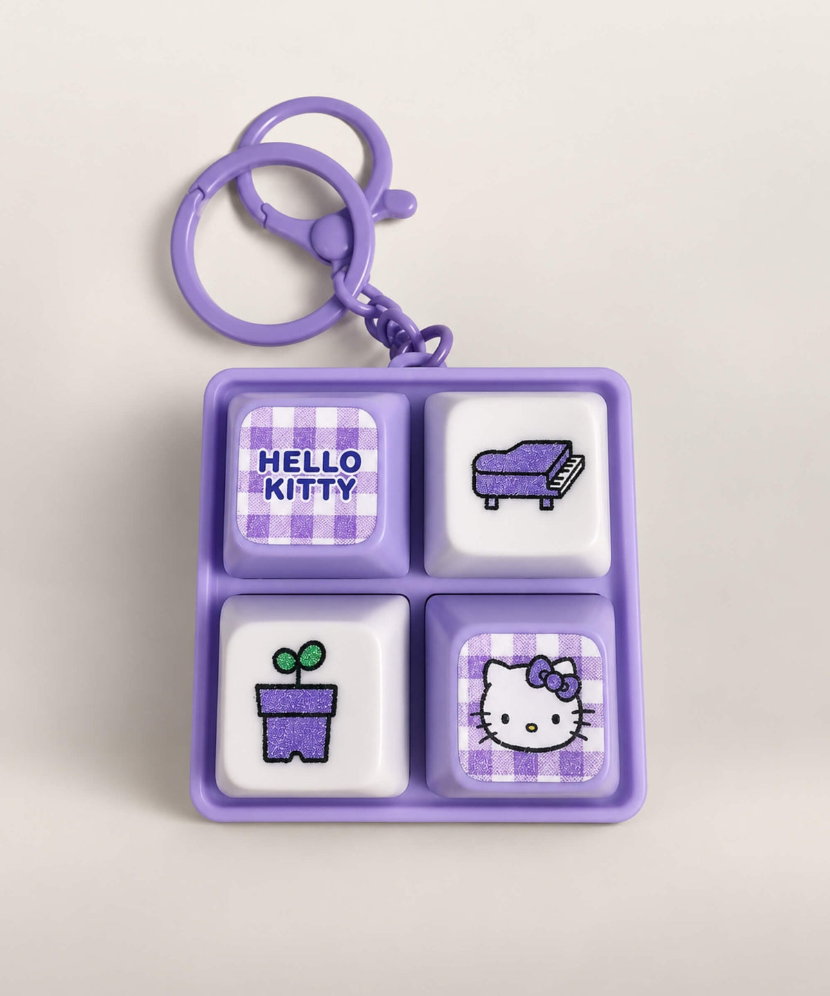 Purple Hello Kitty light up sound button keychain with piano and plant button designs