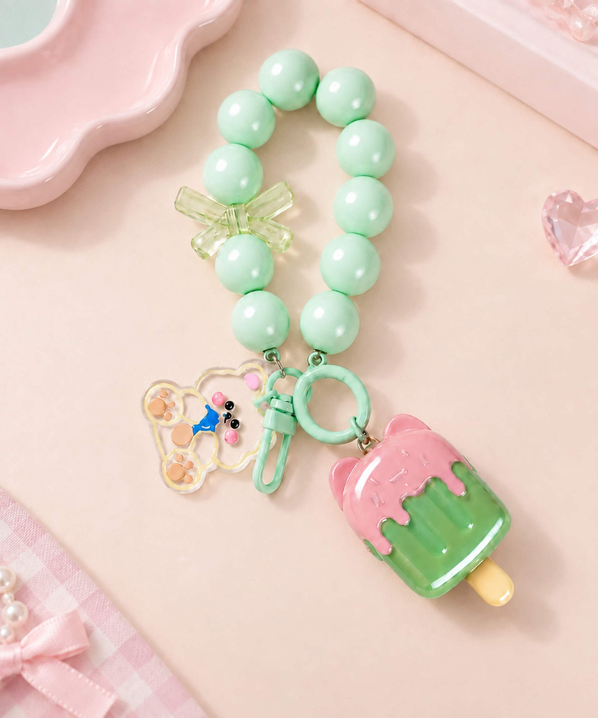 Ice cream beaded keychain with mint green beads, clear bow detail and pink and green ice block charm