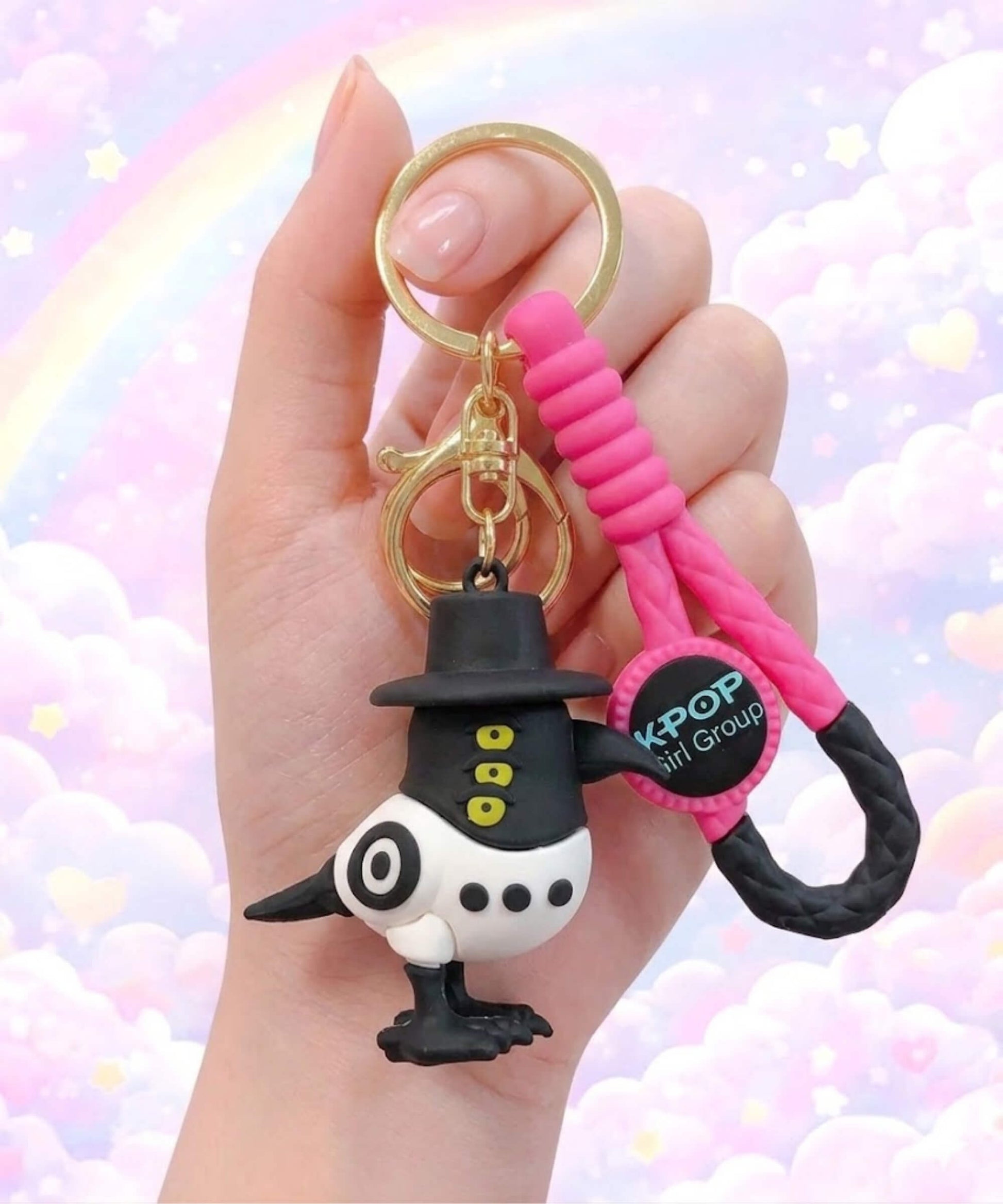 Kpop style demon hunter character keychain close up in hand, cute cartoon bird bag charm inspired by girl group aesthetic