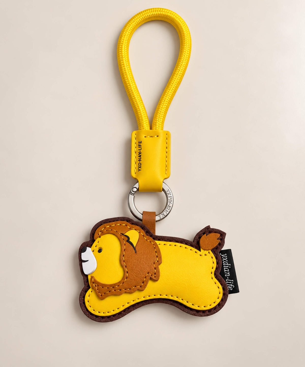Yellow and brown lion PU leather bag charm keychain with stitched mane and tail details
