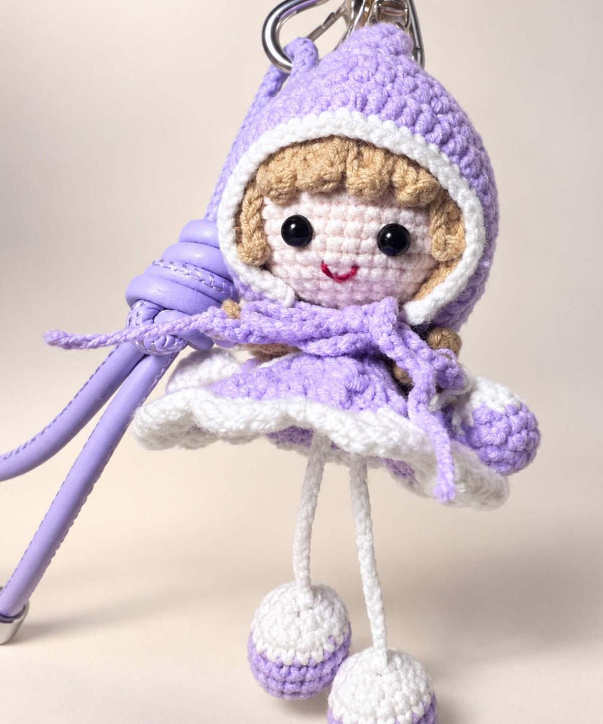 Close-up of purple Little Red Riding Hood style crochet doll keychain