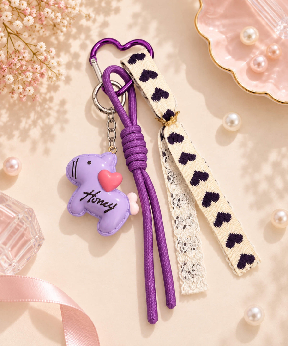 Purple macaron pony resin keychain with heart detail, purple cord strap and ribbon accent