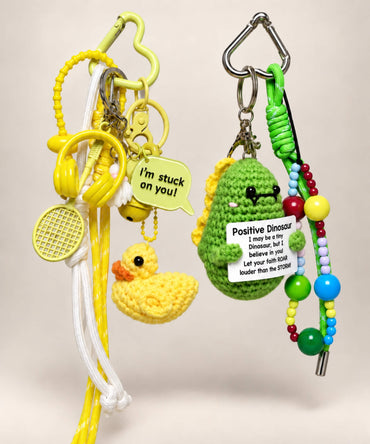 Stuck on You Duck and Positive Dinosaur crochet keychains with colourful charms and cords