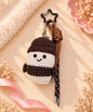 Brown and cream milk tea cup crochet keychain styled on a soft neutral background with decorative ribbon and dried flowers