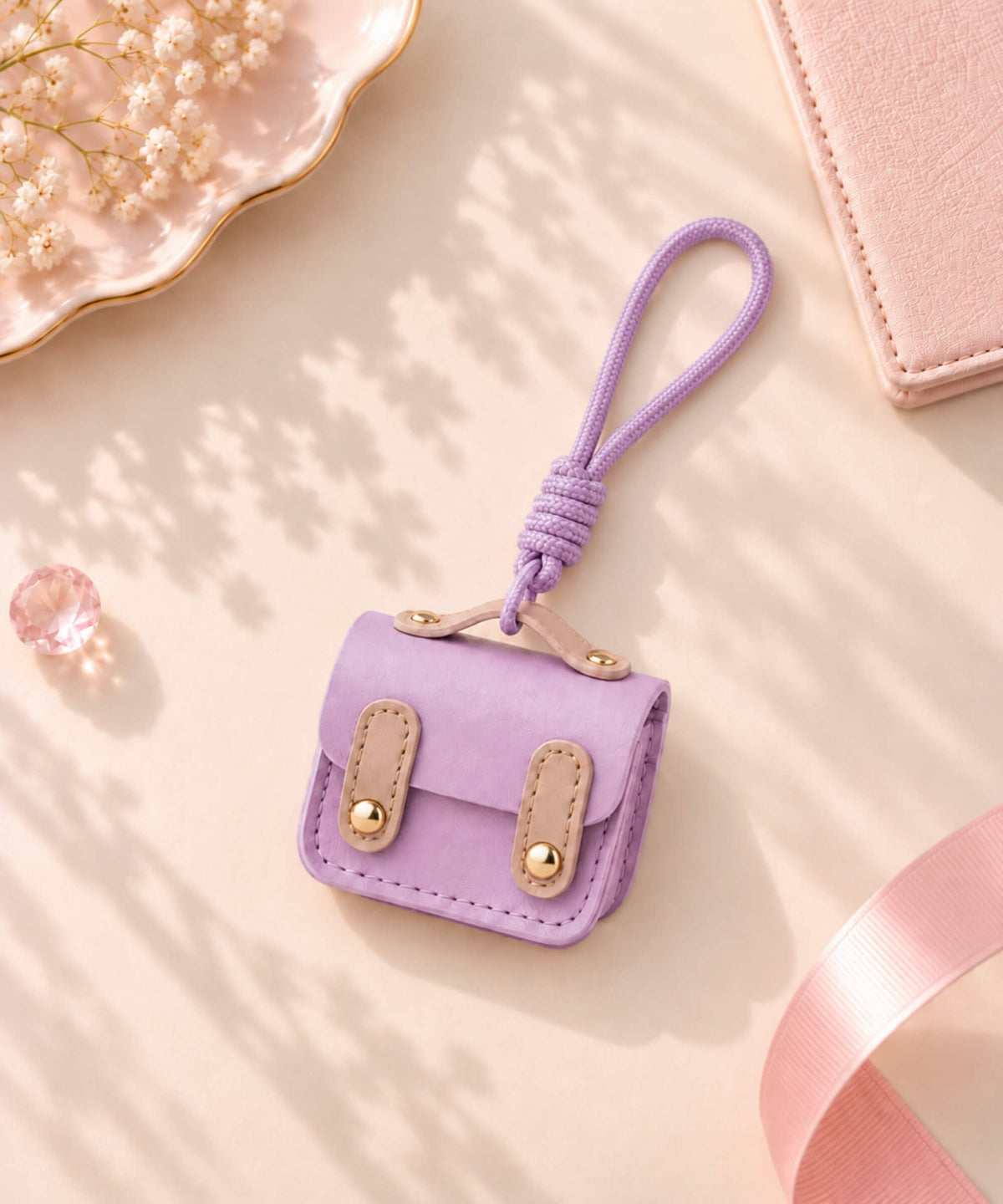 Purple mini earphone pouch PU leather keychain with rope wrist strap and gold-tone details