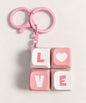 Pink Love mini keyboard fidget keychain with four pressable keys