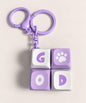 Purple Good mini keyboard fidget keychain with four pressable keys