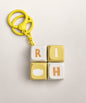 Yellow Rich mini keyboard fidget keychain with four pressable keys