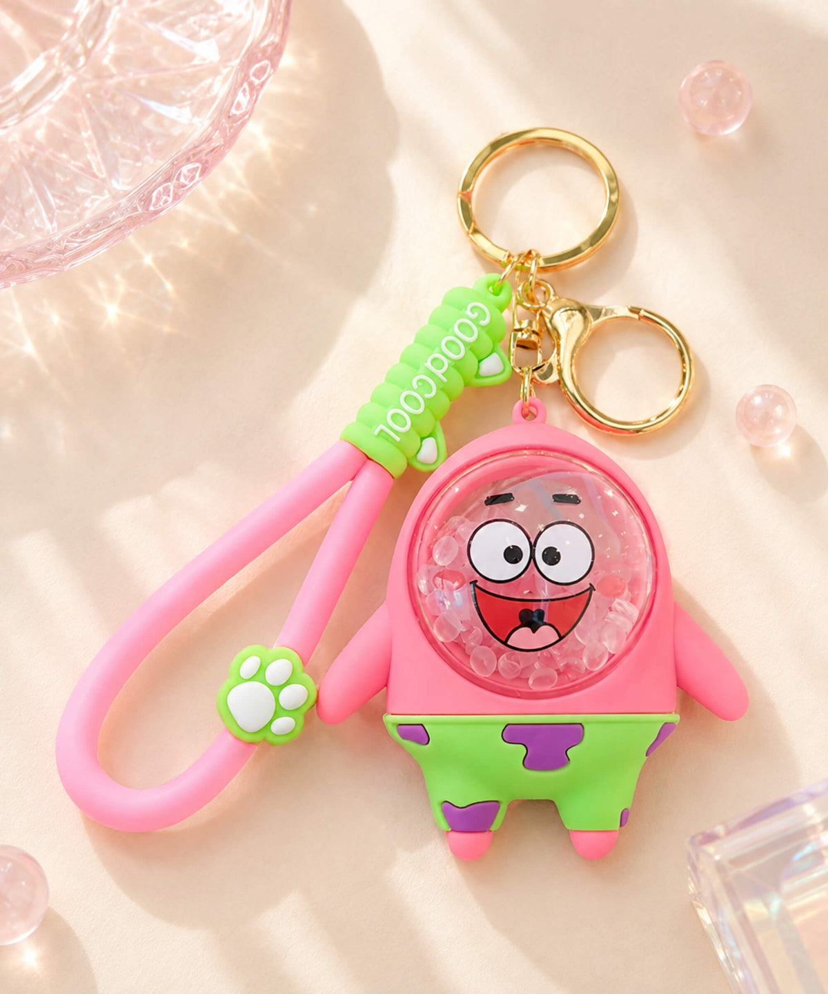 Patrick Star style bubble bead keychain with pink cartoon design, floating clear beads, wrist strap and gold-tone keyring