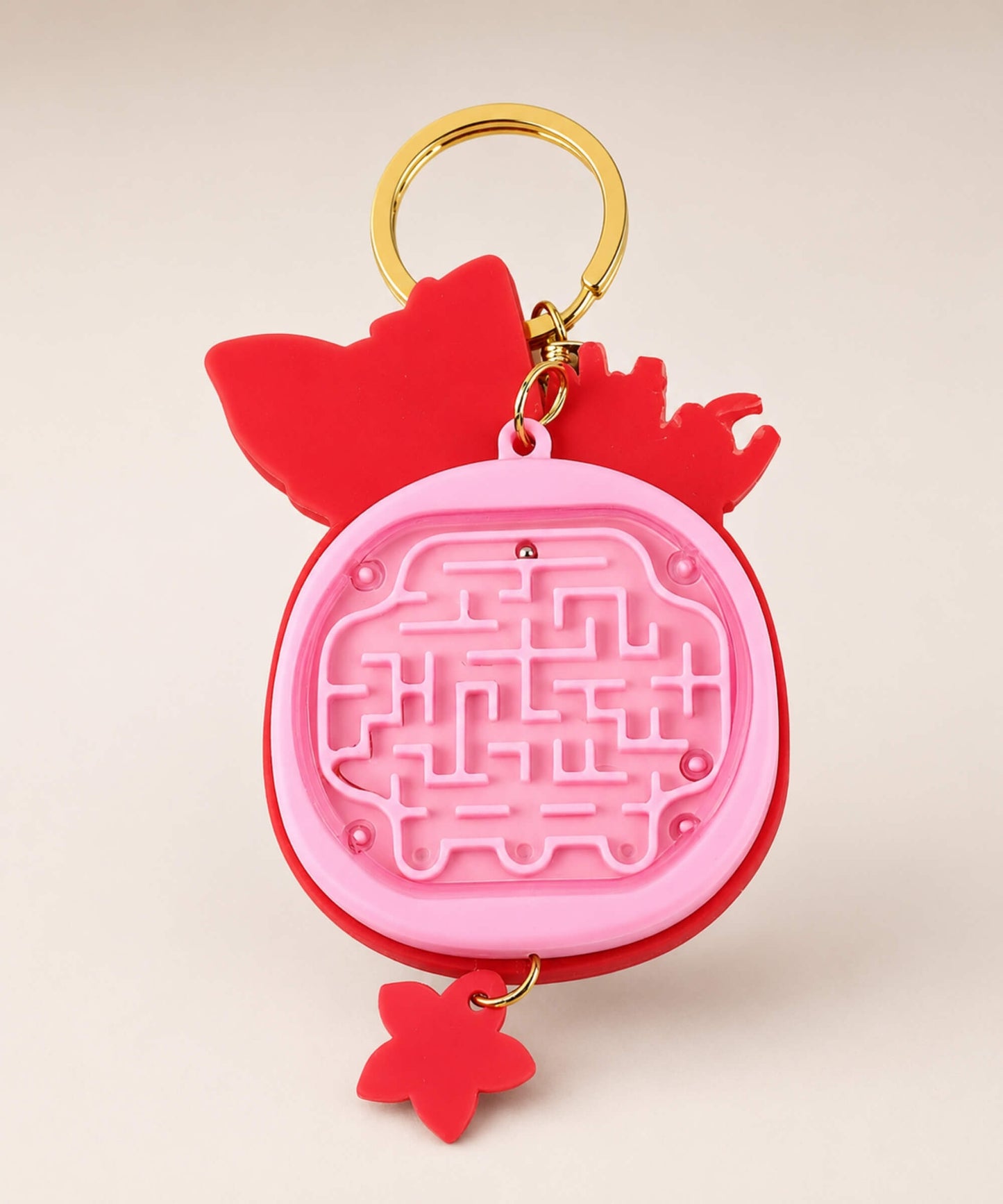Back view of pink fox calculator keychain with mini maze game