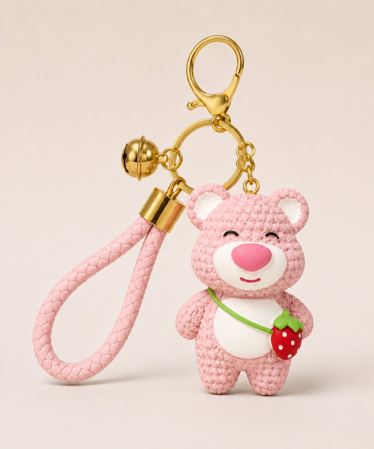 Light pink strawberry bear resin keychain with matching braided wrist strap and gold hardware