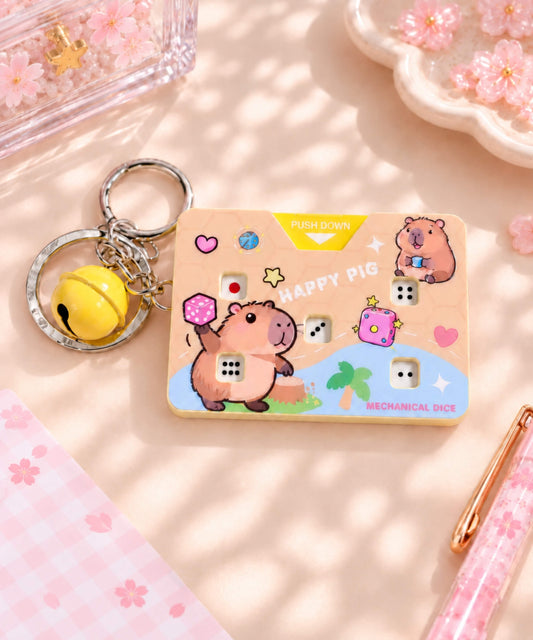Happy Pig Press-to-Roll Dice Game Keychain styled on a desk