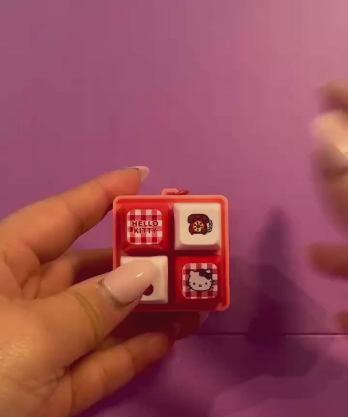 Hello Kitty light up sound button keychain with interactive buttons shown in use