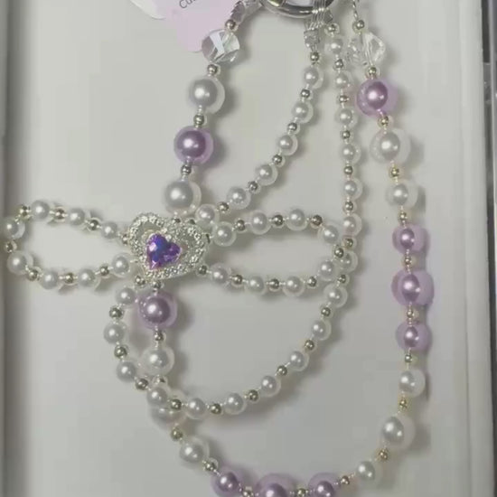 Video of purple heart bow beaded phone charm with pearl-look beads and heart bow detail