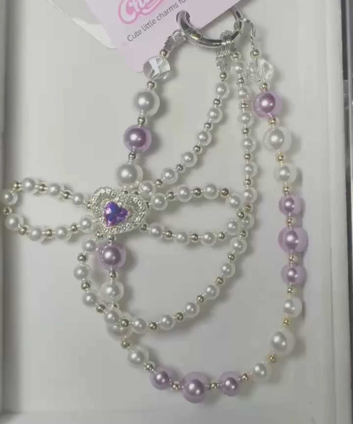 Video of purple heart bow beaded phone charm with pearl-look beads and heart bow detail