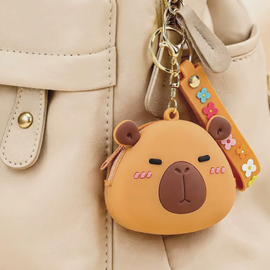 Capybara silicone coin purse keychain hanging on backpack, cute mini wallet bag charm in everyday use