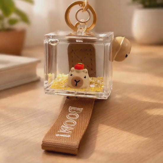 Capybara liquid shaker keychain on desk with soft lighting lifestyle scene