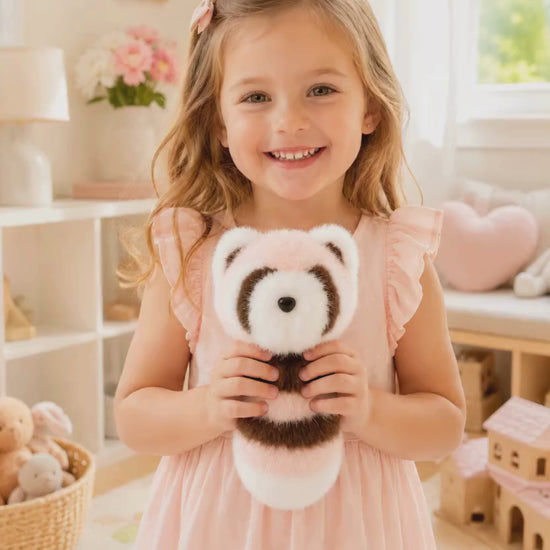 Girl holding raccoon plush keychain