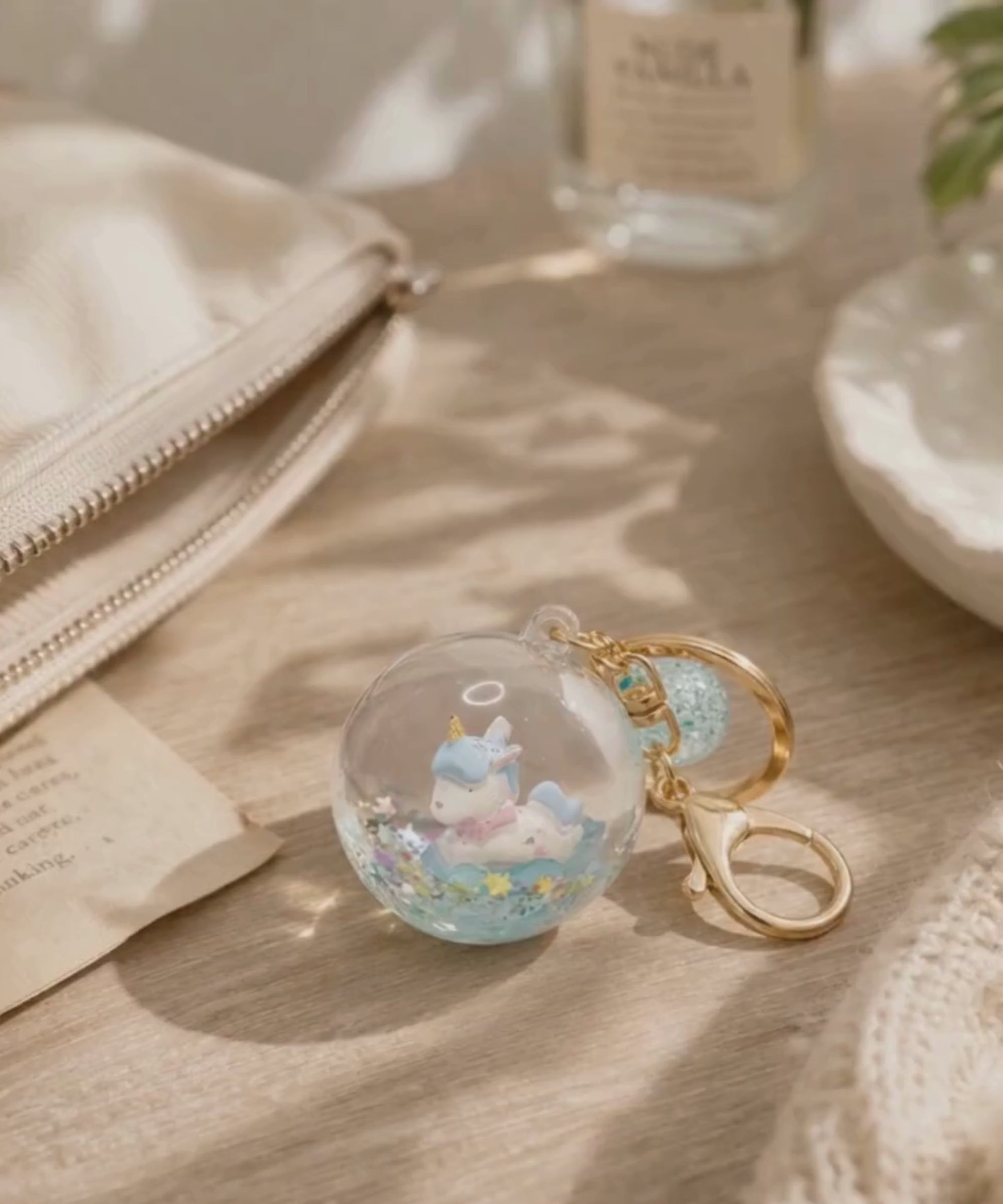 Unicorn liquid glitter keychain on table with soft lighting lifestyle scene